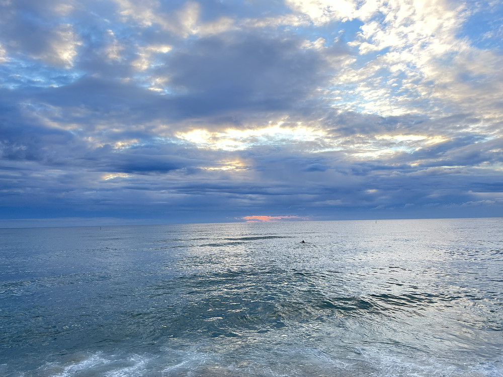Lonely surfer on cloudy day